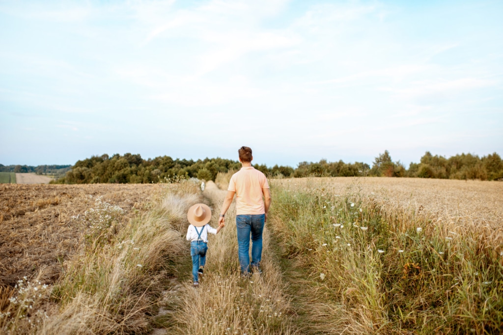 father and son walking in the field 2023 11 27 04 57 39 utc